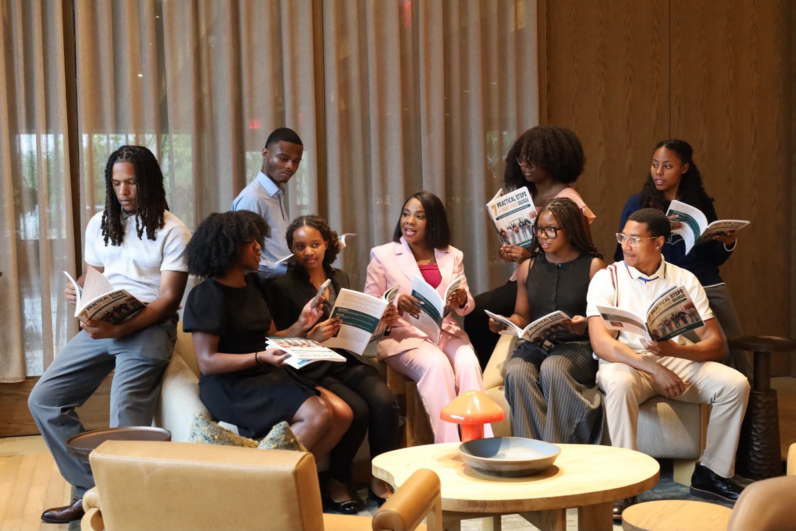 Dr. Janet Antwi reading the book alongside a group of students